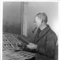 Man Smoking Pipe While Working