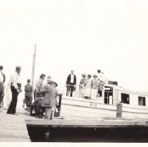 Men and women with cabin cruiser