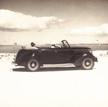 Convertible parked on beach