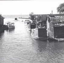 Nu Deal and Bonnie Lass docked in the Leland River in Fishtown