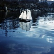 Andrew White's toy sailboat with Wentworth Hotel in background