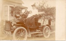 People in old auto at 473 E. Elm Street
