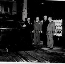 Preston Tucker showing three men the cabin of a Tucker '48