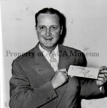 Preston Tucker holding a check