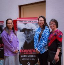 Family of Edward Lennie pose for photo by his induction banner.