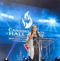 Inductee Susan Auch giving an acceptance speech onstage.