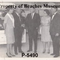 Men and Women in Front of Clothing Displays, undated