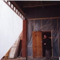 Workman standing in unfinished doorway