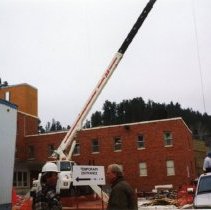 Workmen in construction area outside building entrance