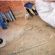 Workman preparing site for foundation work