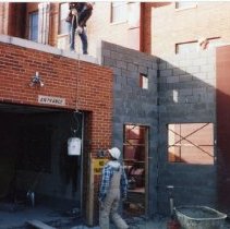 Workers building a block enclosure