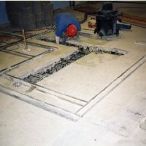 Workman working on concrete floor