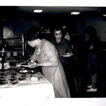 Individuals passing through a line at a cafeteria