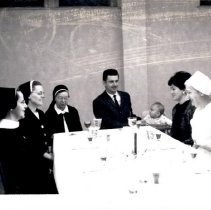 Couple and baby with nuns