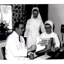 Medical staff reviewing program materials