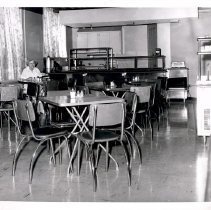 Woman seated in a cafeteria