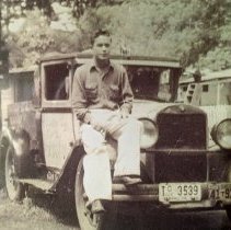 Donald Arionus Sr. sitting on a car in 1945.
