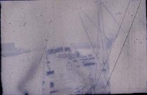 Man Pulling Ropes Onto Boat Deck