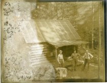 Untitled: Unidentified Men Standing Outside Log Cabin