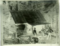 Untitled: Unidentified Men Standing Outside Log Cabin