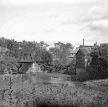 View of a mill and a bridge on a river in the Kincardine area.