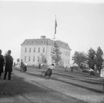 Group playing baseball in a field beside the Kincardine High School.
