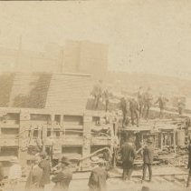 Men gathered around train wreck