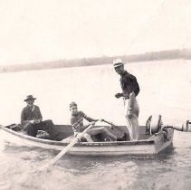 Three men in boat in Stokes Bay
