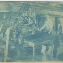 Man working on machine in tannery