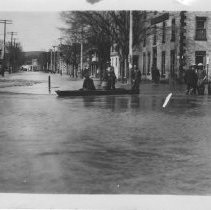 Boating on streets in front of Hartley House, Walkerton after flood
