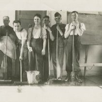 Seven soldiers with brooms and mops