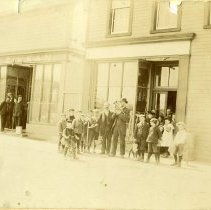 N.B. Zinkan storefront and man with brass instrument