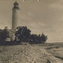 Chantry Island lighthouse with people seated on log