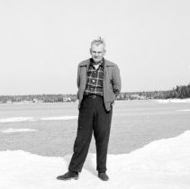 K-64-08-03  Frank Herbert in front of cottage 1964