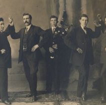 Four men with bagpiper