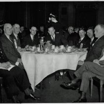 Men around a table, including Harry Downey, Bert Begg ...