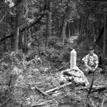 K-61-04-17 Howard at one of original survey markers, 1961