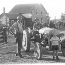 Bob, John and Ronald MacLennan with tractor on family farm