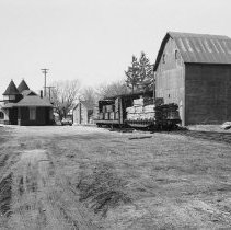 K-72-05-28 C.N.R. Station and loads of lumber, Chesley, April 1972