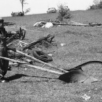 K-74-14-35 Alden Rourke posing holding the handles of a walk-behind plow