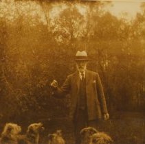 A2018.049.017-01 - Alexander McNeill outside with several dogs