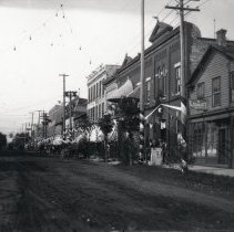 View down business street, Kincardine, showing many decorated storefronts.