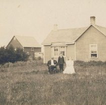 John Klippert, woman and boy near house