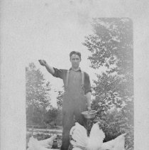 Man feeding chickens.