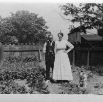 Man, woman and dog in the garden