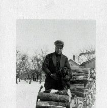 Man and a dog by the wood pile