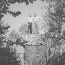 Two men on top of natural bridge