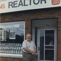 Archie Perkins in front of A.W. Perkins Realtor storefront, Southampton