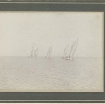 Five sailing boats on open water - Front