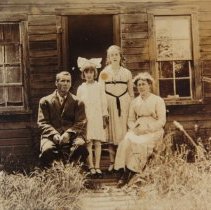 Lewis family in front of cottage on the McNeill estate